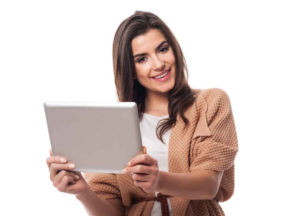 Image of a beautiful woman holding digital tablet and working on it